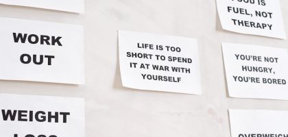 Motivational quotes on white paper promoting healthy habits and lifestyle changes.