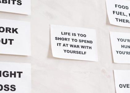 Motivational quotes on white paper promoting healthy habits and lifestyle changes.